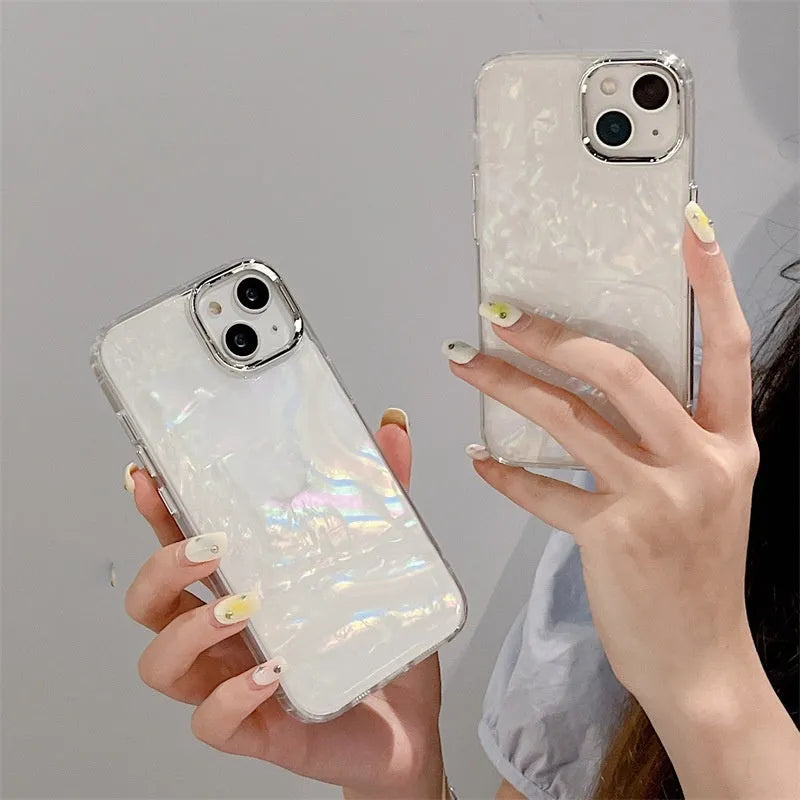 White TPU phone case with fantasy shell pattern compatible with iPhone 13 showing back design and side buttons