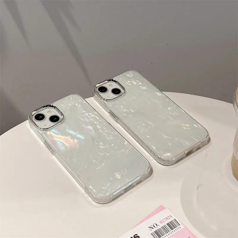 White TPU phone case with fantasy shell pattern compatible with iPhone 13 showing back design and side buttons