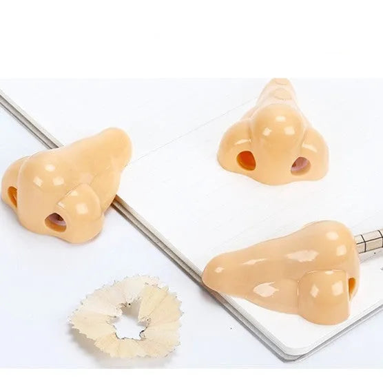 Flesh coloured plastic pencil sharpener with big nostril design for manual pencil sharpening