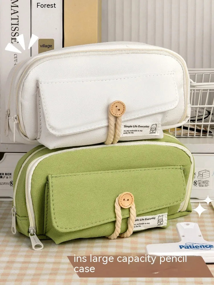 Green Korean-style canvas pencil case open, showing large capacity for pens and stationery.