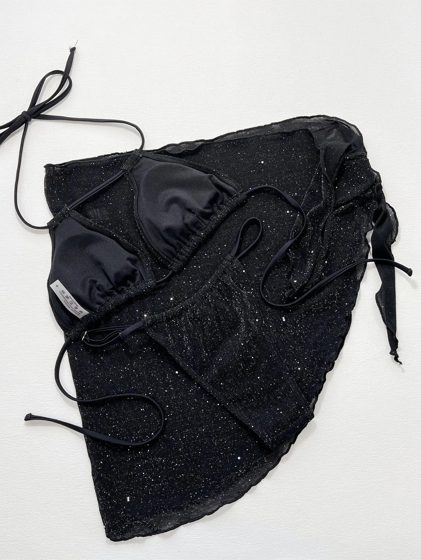Black three-piece polyester bikini swimsuit set with top and shorts on mannequin