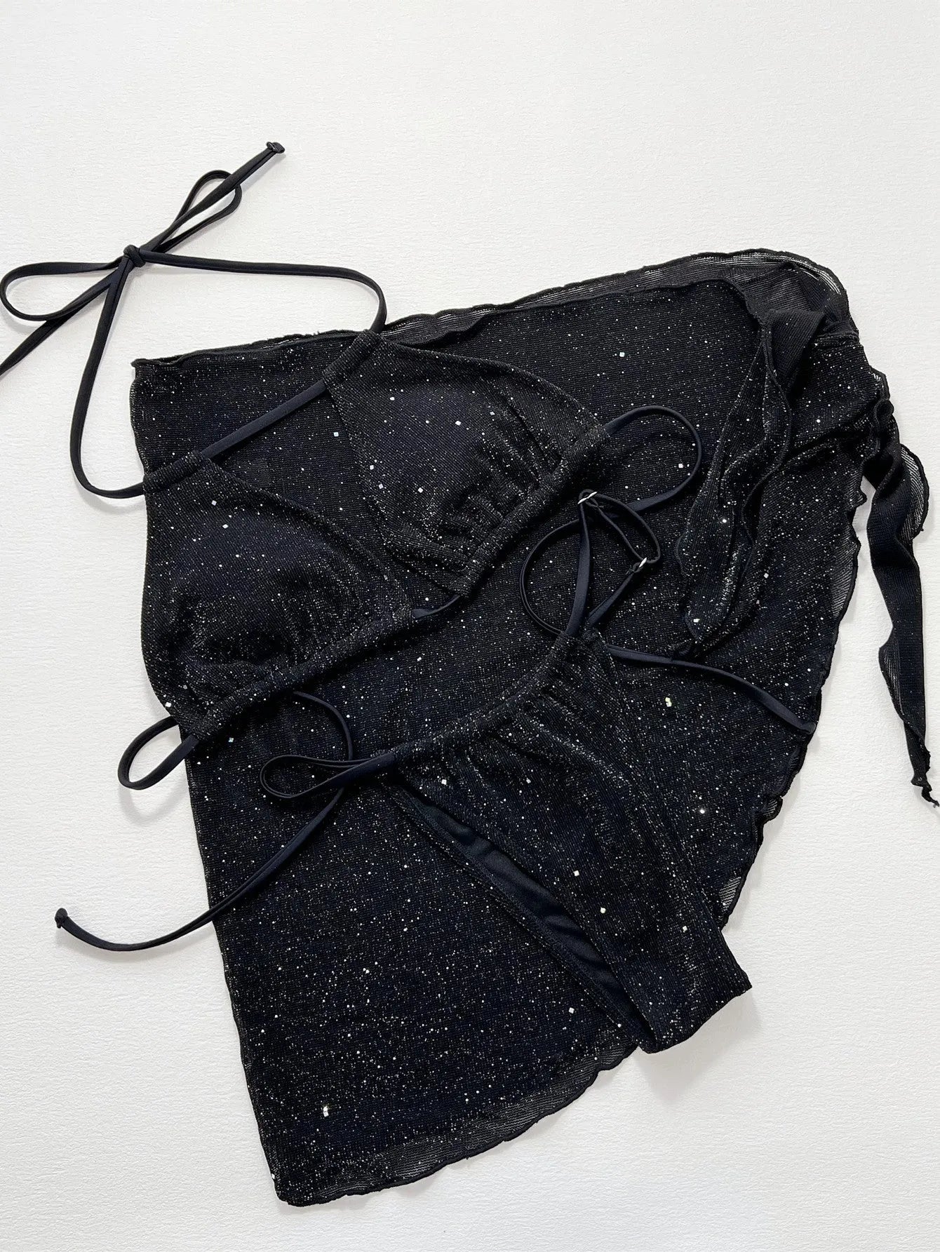 Black three-piece polyester bikini swimsuit set with top and shorts on mannequin