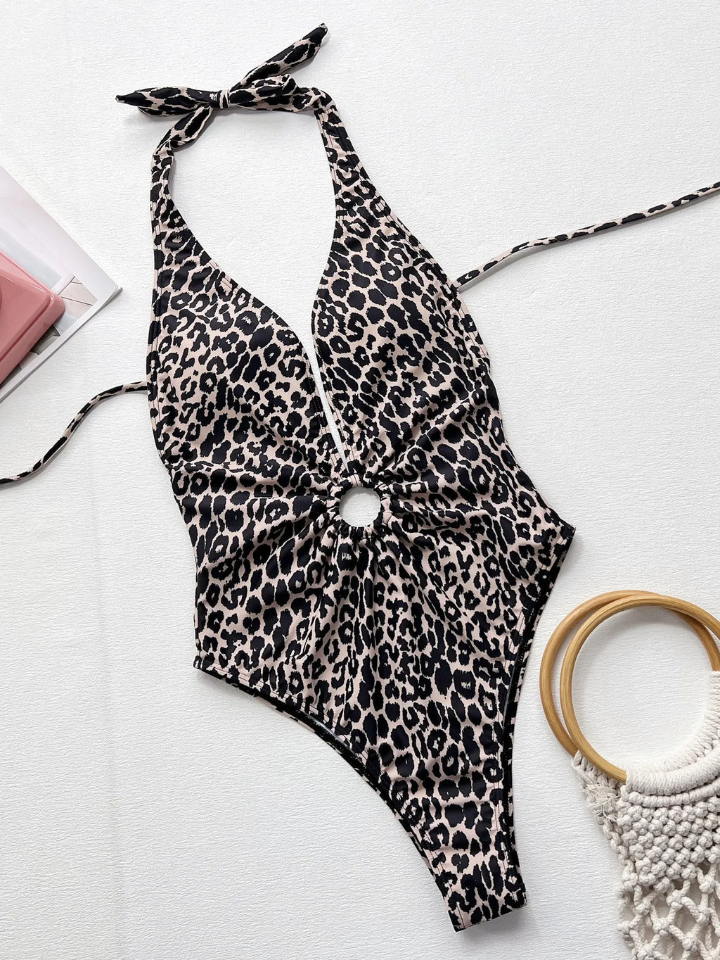 Leopard print women's one-piece swimsuit with hollow-out ring design on a mannequin.