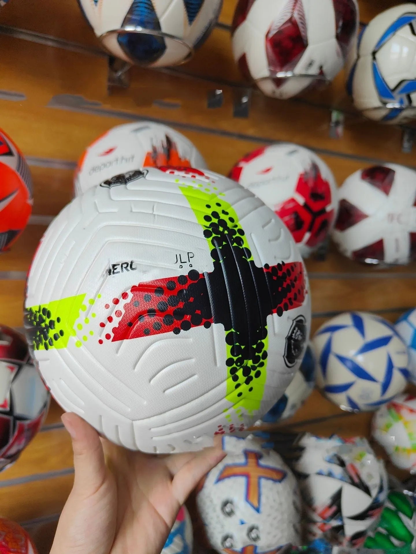 Fluorescent green Size 5 football on a pitch for training and matches.