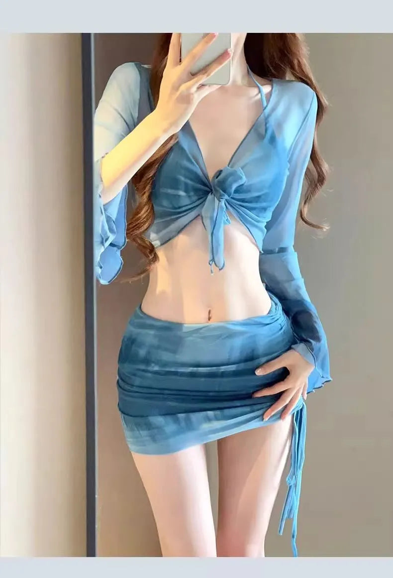 Women's blue four-piece bikini swimsuit set with high-waist briefs and ruffle skirt