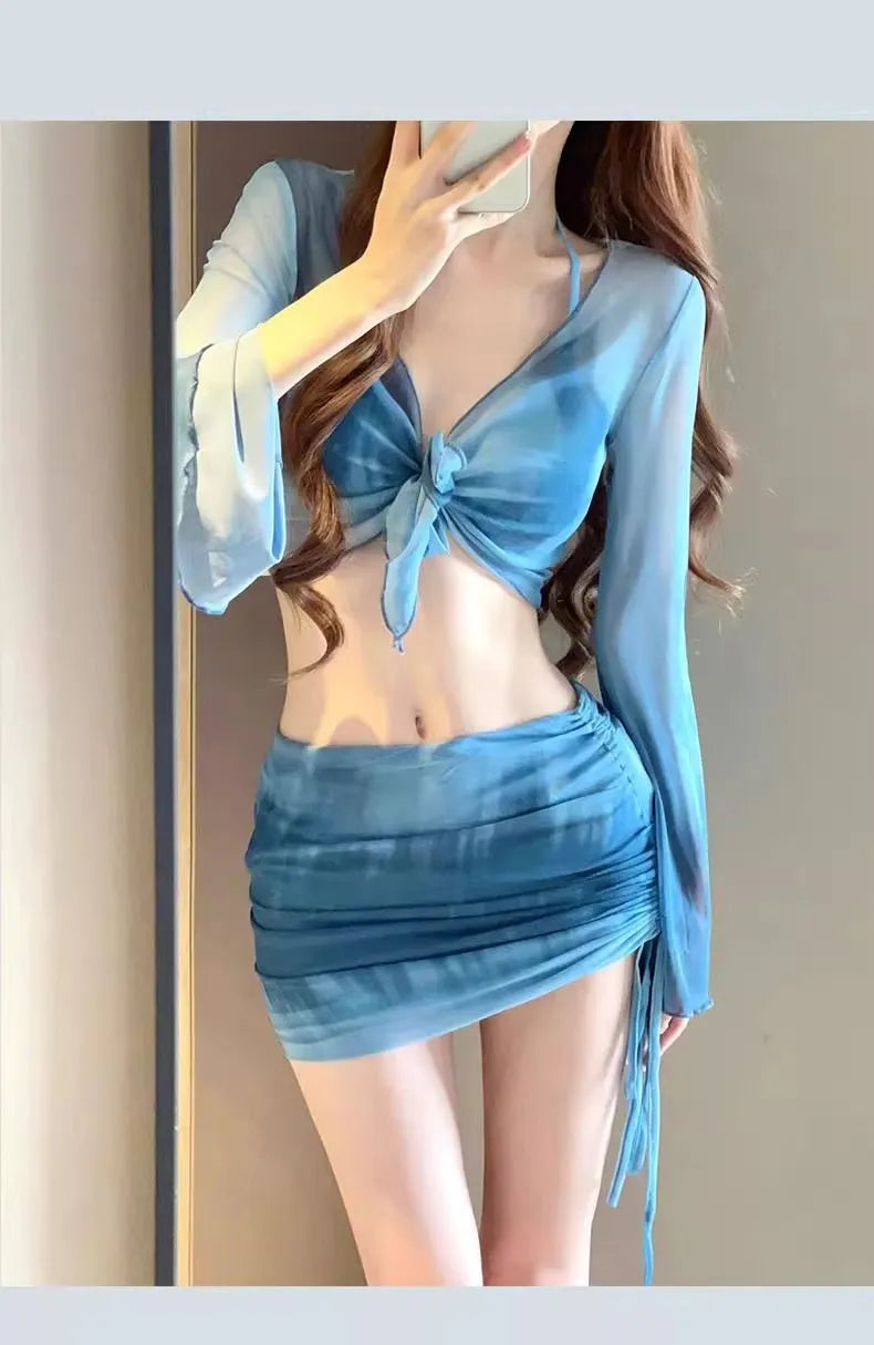 Women's blue four-piece bikini swimsuit set with high-waist briefs and ruffle skirt