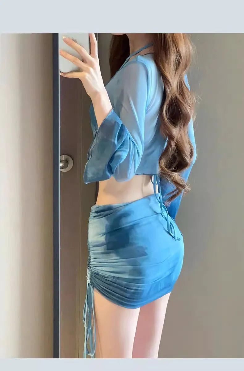 Women's blue four-piece bikini swimsuit set with high-waist briefs and ruffle skirt