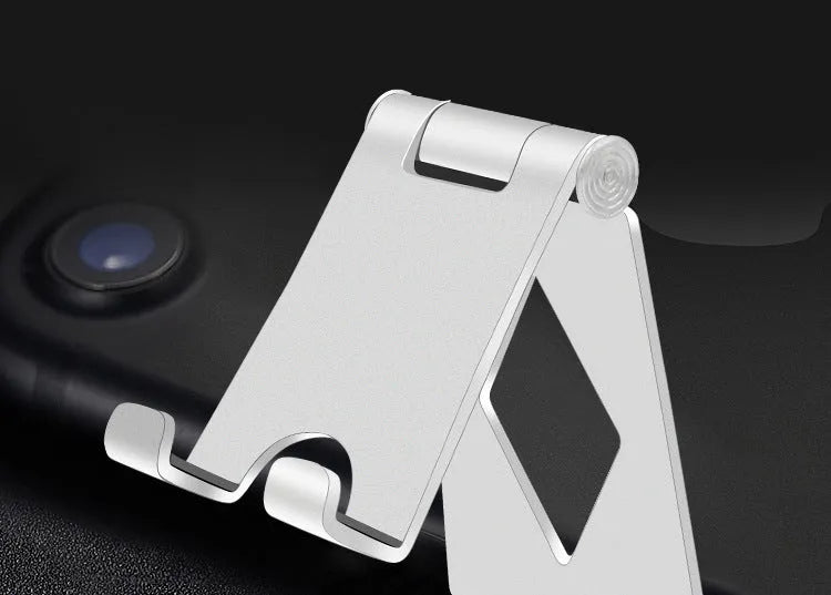 Aluminium alloy folding mobile desktop stand in metallic finish on a desk