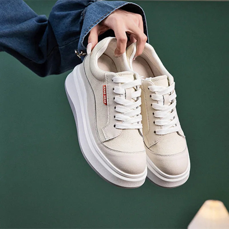 Women's beige leather board shoes with thick soles for height increase on neutral background