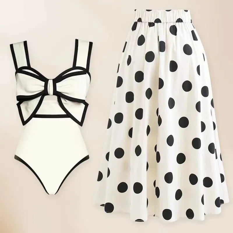 Women's black one-piece swimsuit with white round skirt and bow decoration on front