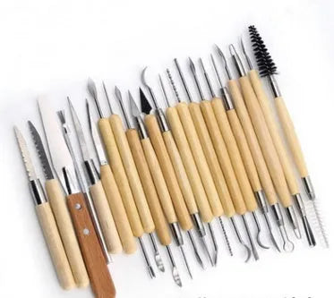 Brown OPP bag containing 27-piece pottery tool set with stainless steel, wood, and plastic sculpting implements.