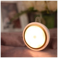 Circular white motion sensor LED light unit showing warm and white light options, 80mm diameter.