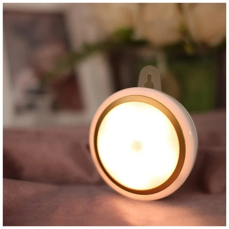 Circular white motion sensor LED light unit showing warm and white light options, 80mm diameter.