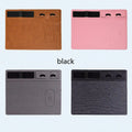 Pink wireless charging mouse pad with integrated mobile phone holder on a desk.