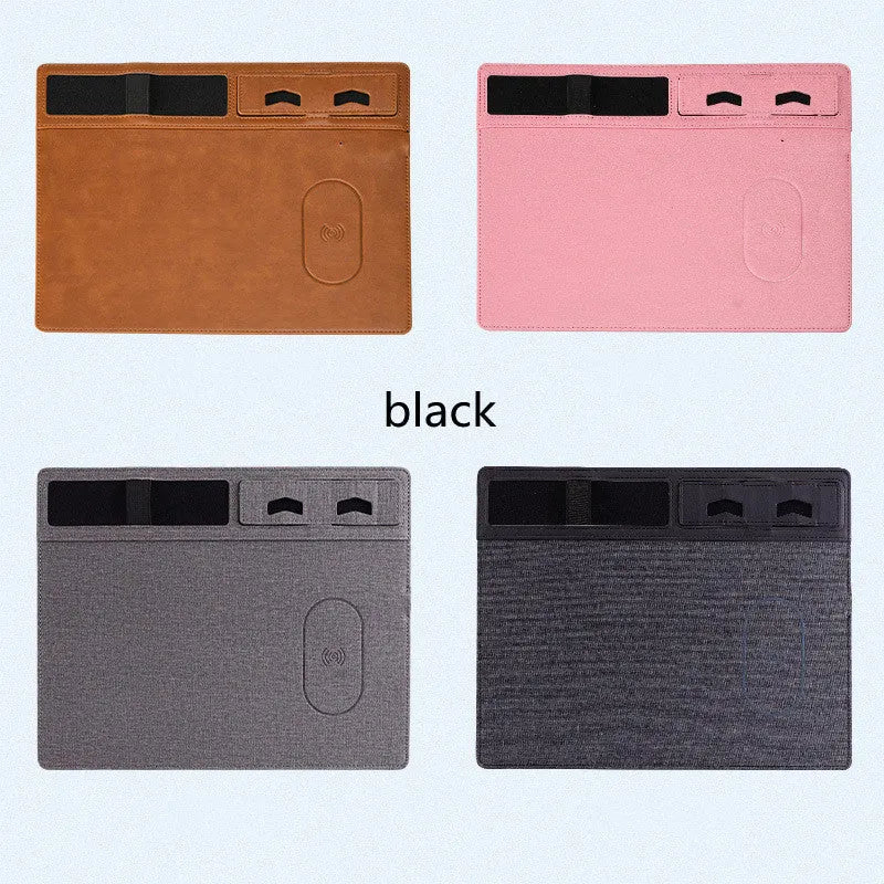 Pink wireless charging mouse pad with integrated mobile phone holder on a desk.