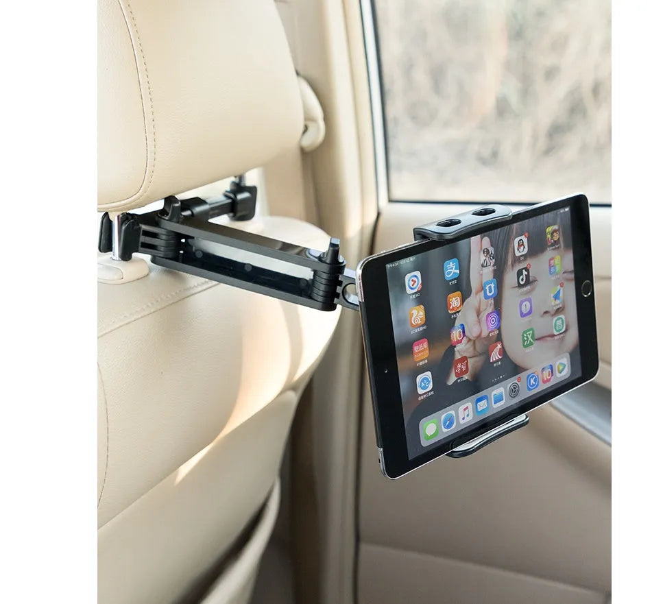 Black universal car phone holder mounted on rear seat centre armrest with tablet secured in snap-in mount