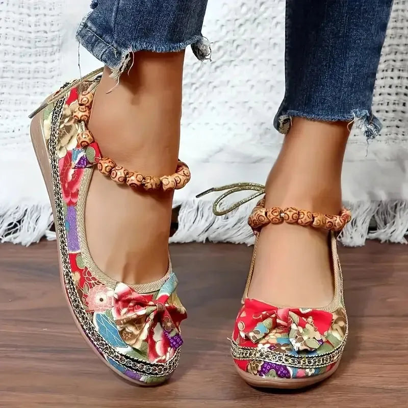 Women's black ethnic platform sandals with elastic band and cloth upper on a plus size foot.