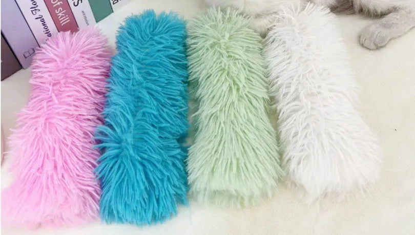 Green, white, blue, and pink plush cat toy pillow measuring 27cm by 10cm