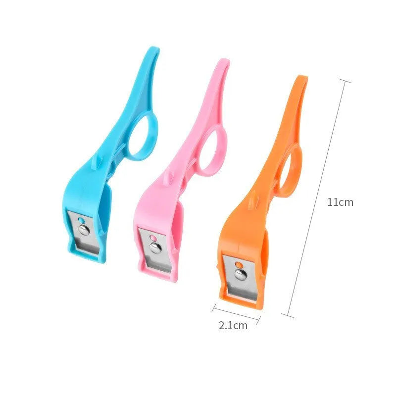 Multifunctional fruit peeler with finger ring and stainless steel blade in pink, blue, and orange colours