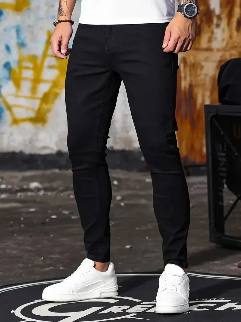 Man wearing retro wash stretch slim fit five-quarter length jeans in blue with zipper and five-pocket design