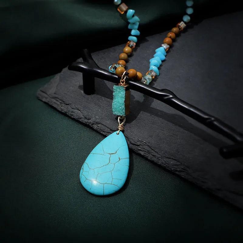 Turquoise blue necklace with water drop shaped pendant on ball bead chain