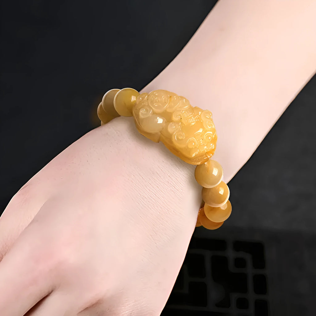 Hand-carved Jinsi Jade money bracelet showing golden thread patterns with jade beads