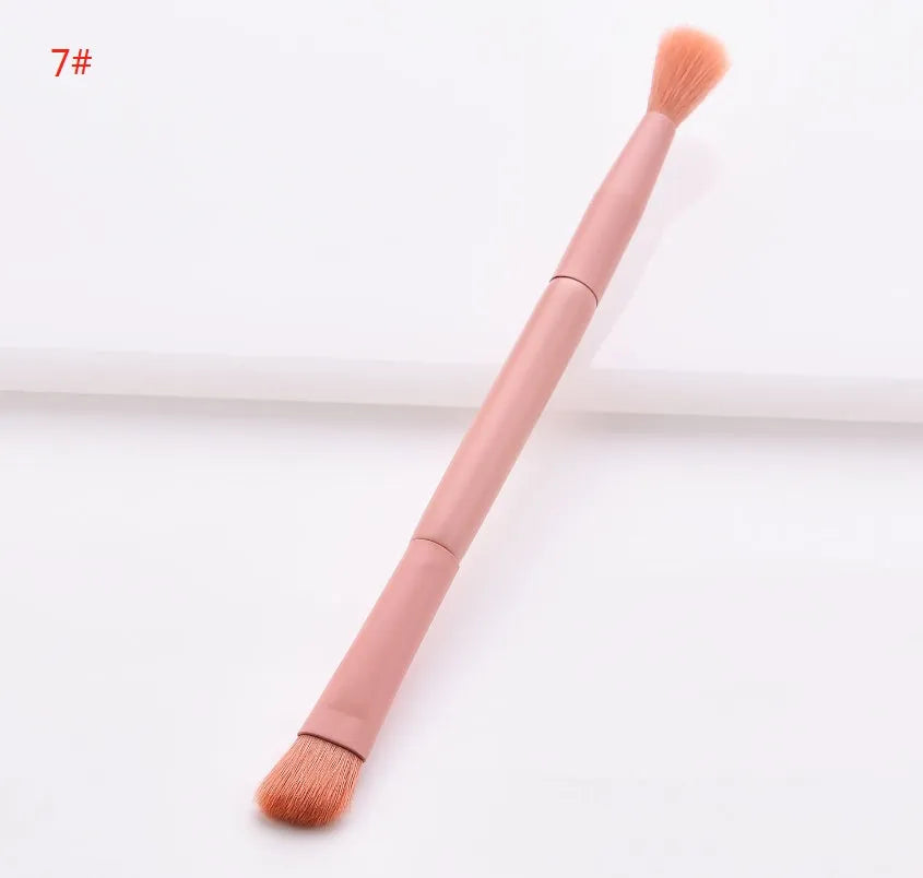 Ten cosmetic makeup brushes with wooden handles arranged showing various brush head shapes and sizes