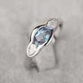 Women's geometric ellipse ring with inlaid zircon stones in white gold finish showing angular design details
