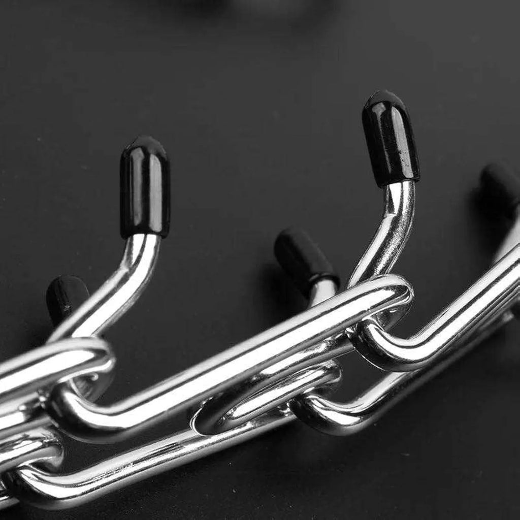 Stainless steel dog pinch training collar with adjustable chain links and black rubber comfort tips on prongs.