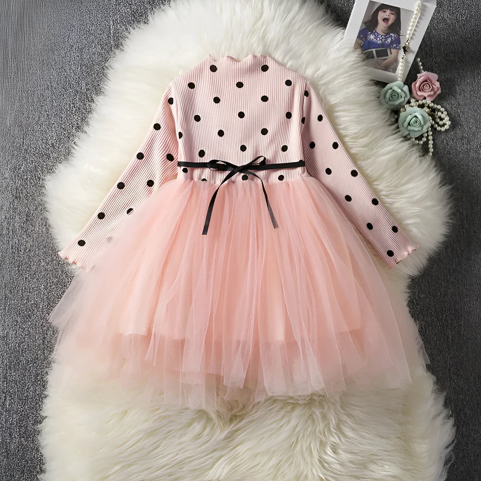 A baby girl's long sleeve black tutu dress with lace detail, suitable for birthdays and christenings.