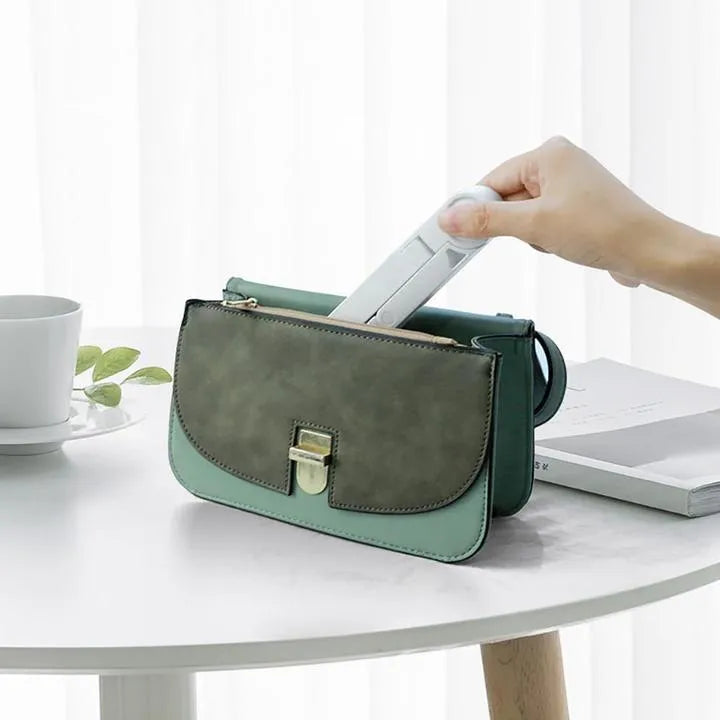 Foldable tablet holder in black showing both folded flat and opened positions with smartphone mounted