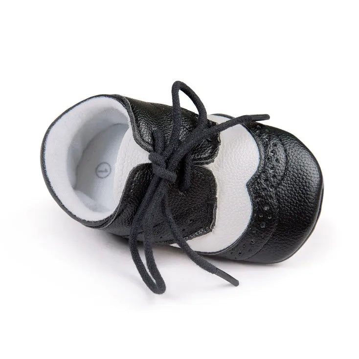 Vintage style soft-soled baby walking shoes for boys in black, grey, light brown, and white.
