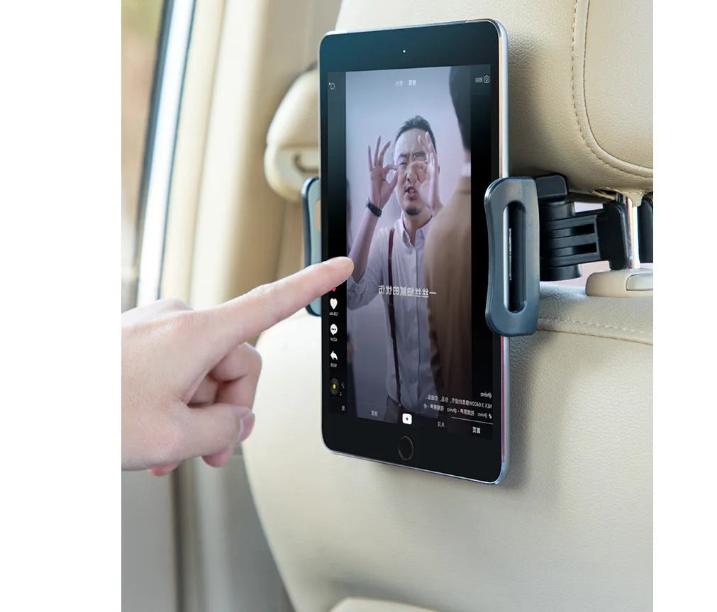 Black universal car phone holder mounted on rear seat centre armrest with tablet secured in snap-in mount