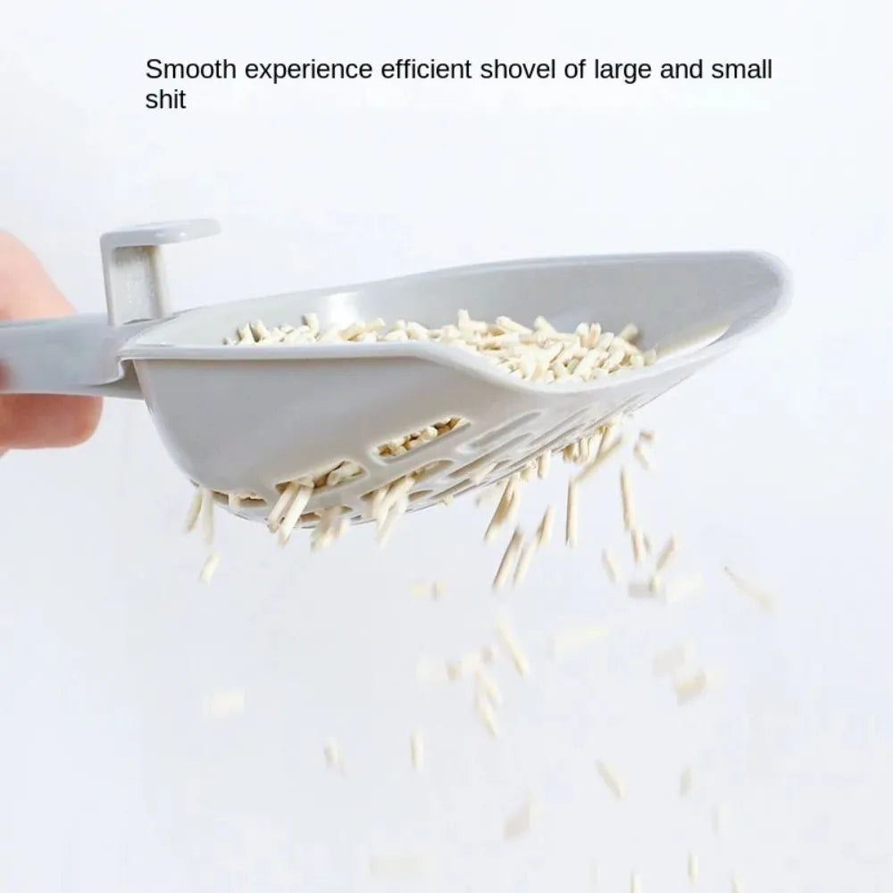 Grey plastic cat litter scoop sitting in its matching storage base