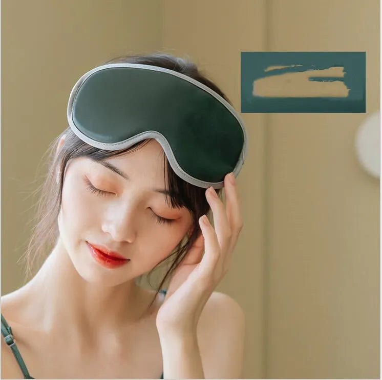 Green portable eye massage mask with USB cable on a grey background