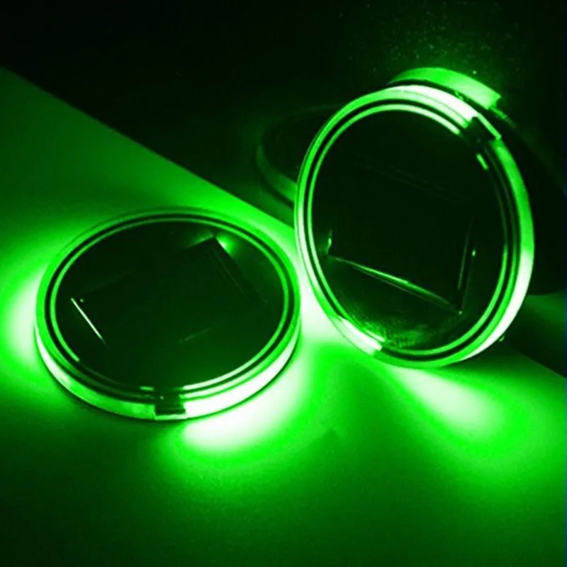 Solar-powered LED cup mat in blue, 7.2cm diameter, with solar panel on a windowsill
