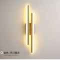 Minimalist Scandinavian LED wall light with black metal arm and white acrylic shade mounted on a wall.