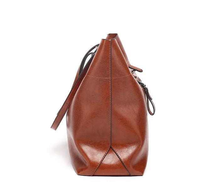 Horizontal leather crossbody handbag in waxed cowhide with two main compartments and a phone pouch.