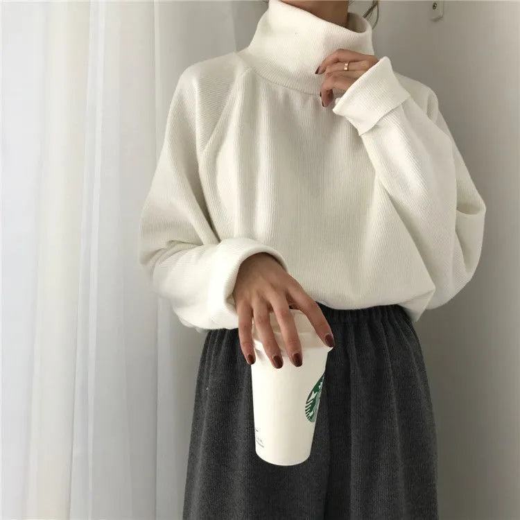 Women's half-high collar long sleeve top in polyester available in apricot, black and white colours