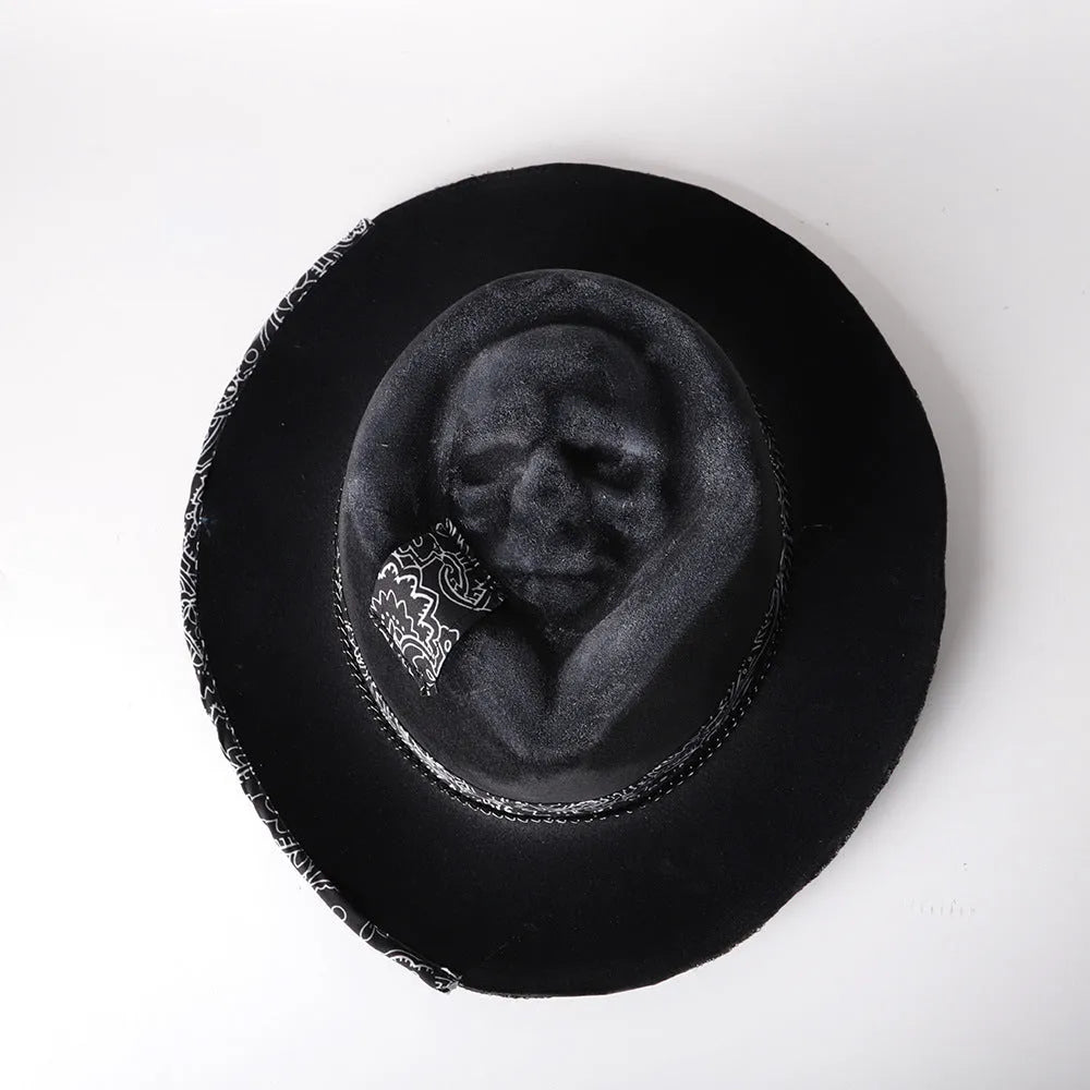 Handmade wool skull hat with conical crown and black and white embroidery for Halloween costumes.