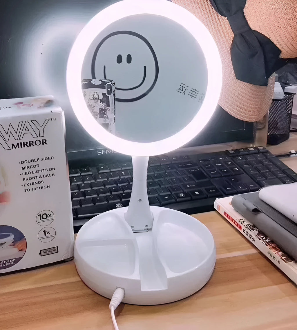 White foldable LED vanity mirror with USB charging port and built-in storage compartments on a table.