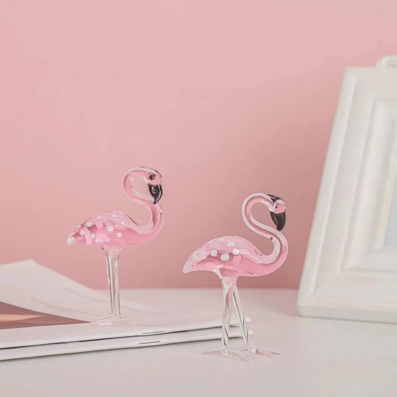 Pink crystal flamingo decorative sculpture on a table, modern simple style.