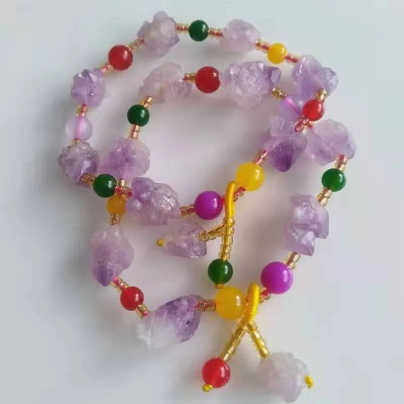Natural shaped amethyst bead bracelet with fu character element on wrist