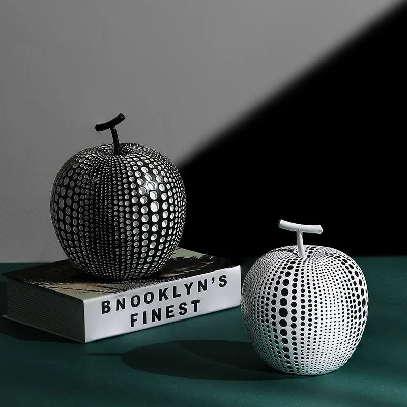 Resin decorative fruit crafts showing apple and pear shapes in black, white and orange colours