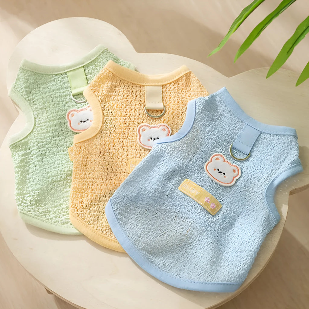 Cat wearing breathable hollowed-out knitted clothing with cartoon bear patch in blue colour