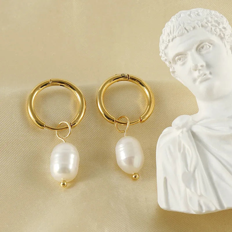 Gold geometric women's earrings with freshwater pearls on stainless steel and titanium posts.