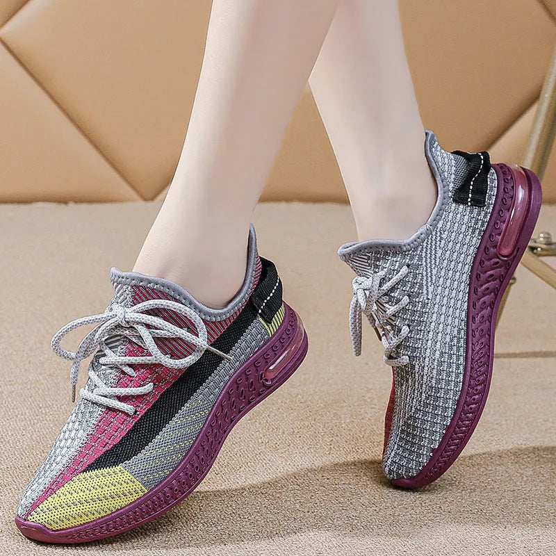 Women's purple low-top lace-up running shoes with round toe and plastic sole on a white background.