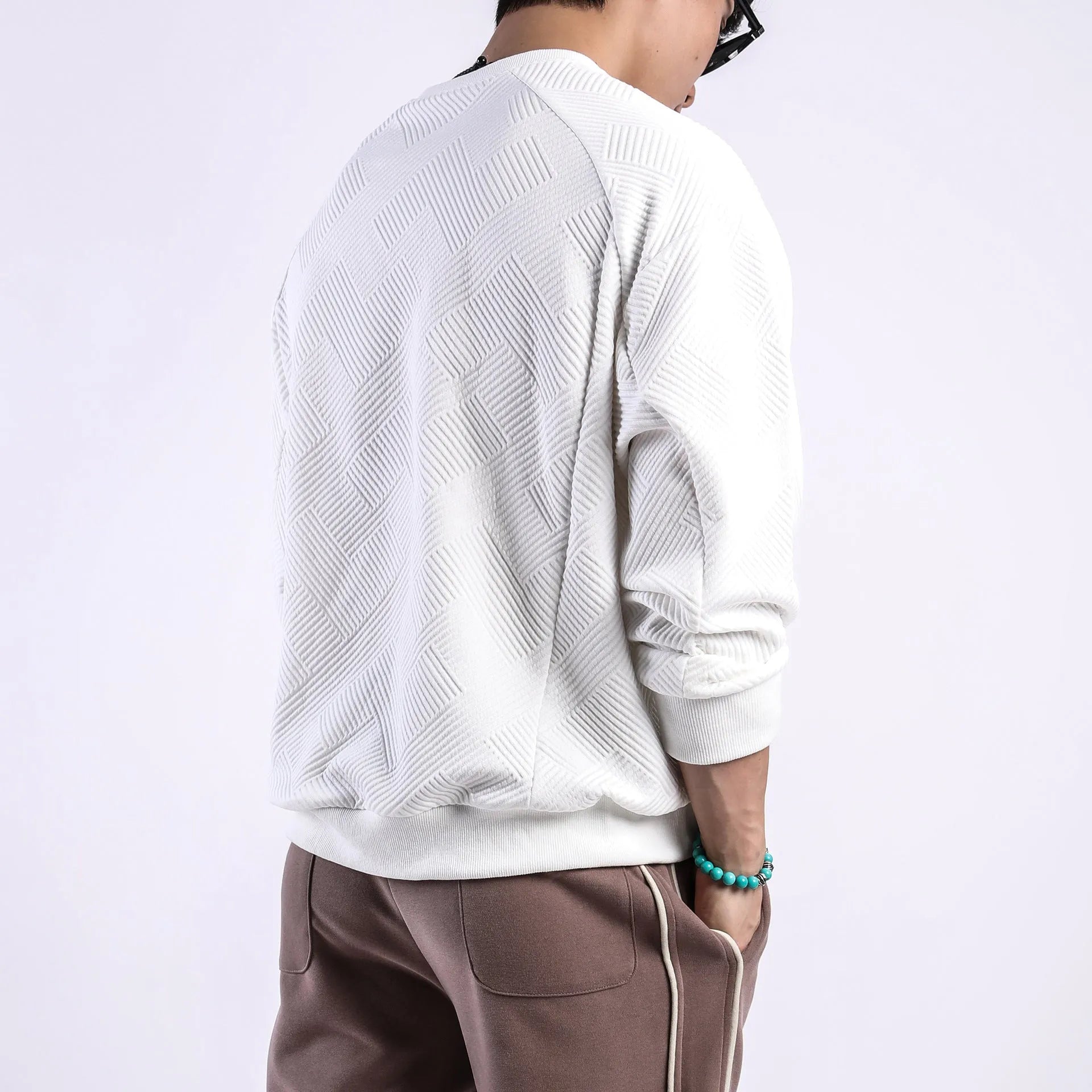 Men's solid colour twill jacquard long-sleeved pullover sweater in a loose fit.