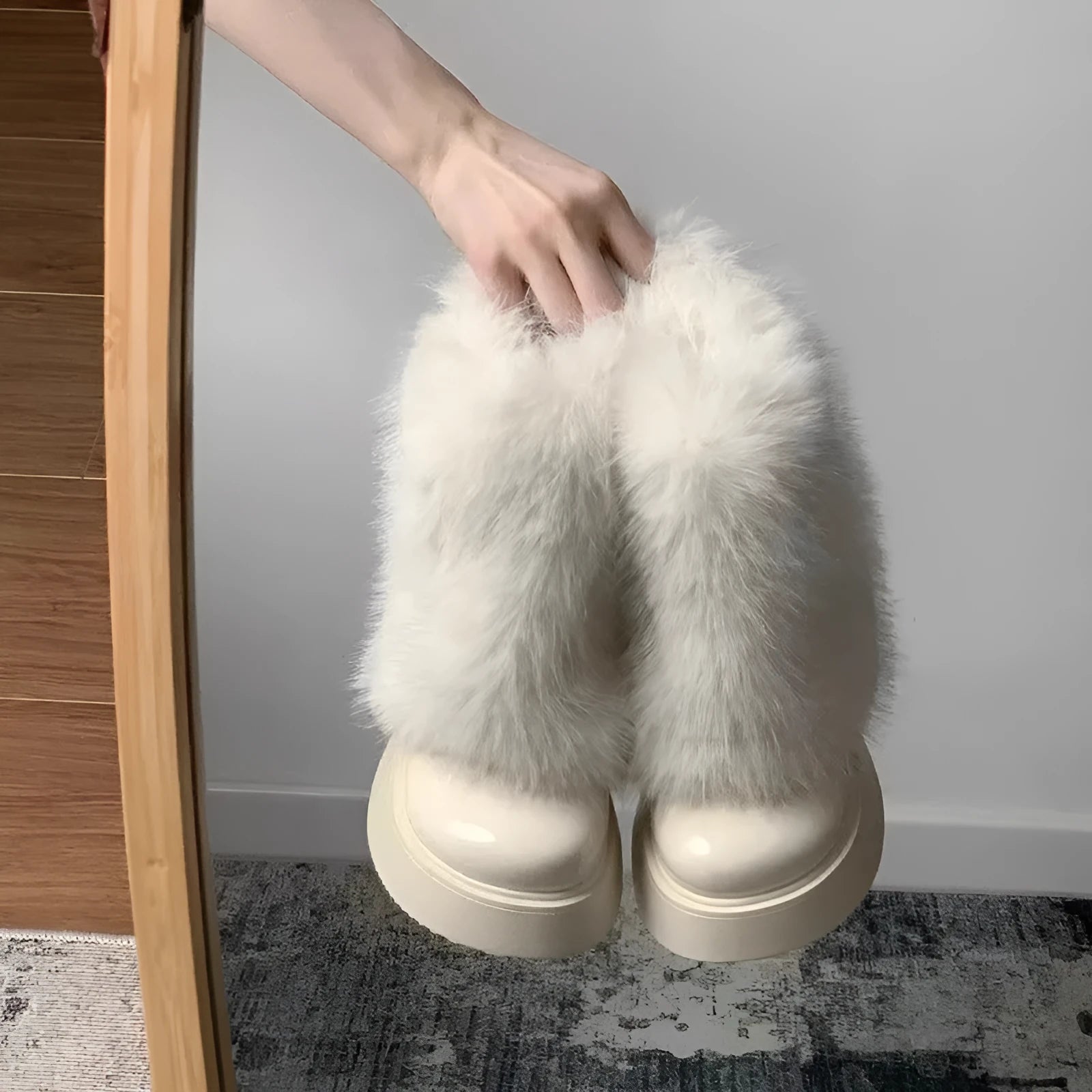 Women's black artificial plush snow boots with a low-top design and a waterproof rubber platform sole.