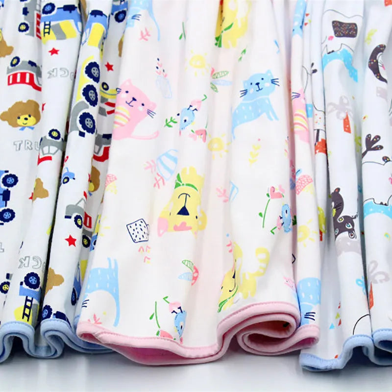 Baby girl wearing a multi-colour waterproof cotton diaper skirt with elastic waistband for belly protection